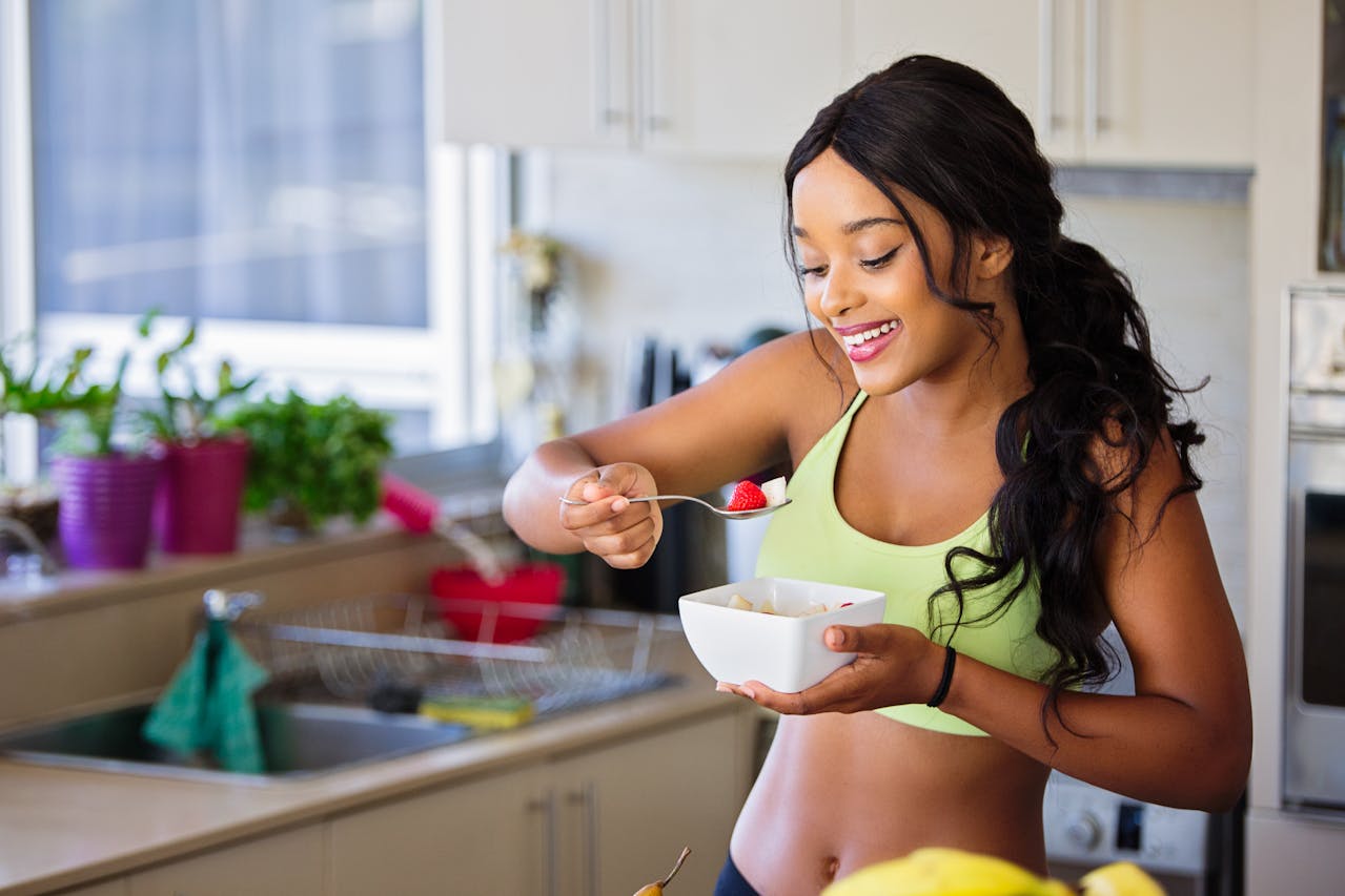 A healthy, active woman smiling, representing the positive impact of folic acid on energy and vitality.