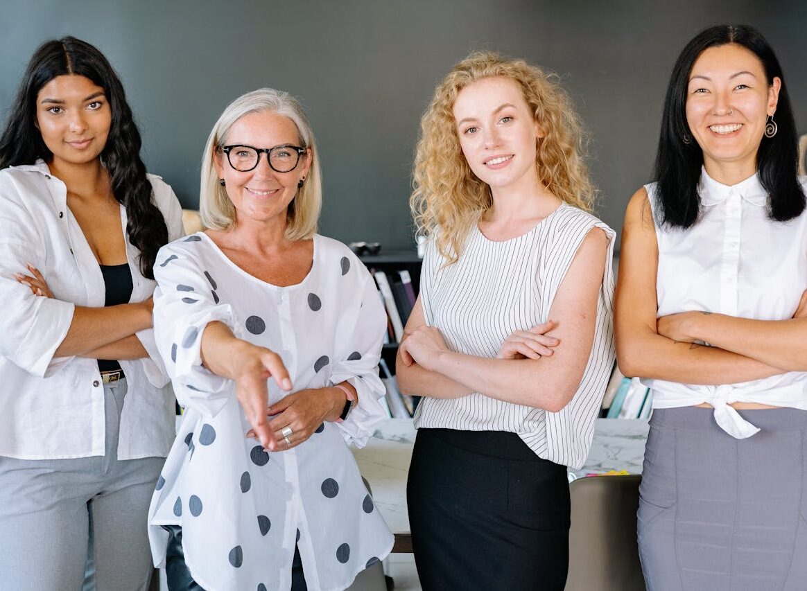 Women of different ages smiling, representing the benefits of folic acid for all life stages.